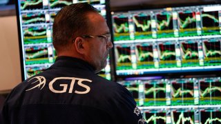 A trader works on the floor of the New York Stock Exchange (NYSE) at the opening bell on March 5, 2025, in New York City.