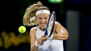 Victoria Azarenka plays a backhand against Iga Swiatek of Poland in their second round match during day three of the Dubai Duty Free Tennis Championships, part of the Hologic WTA Tour at Dubai Duty Free Tennis Stadium in Dubai, United Arab Emirates, on Feb. 18, 2025.