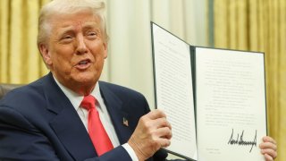 U.S. President Donald Trump holds an executive order in the Oval Office, at the White House in Washington, D.C., U.S. March 6, 2025. 