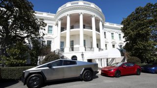 Tesla vehicles, including a Cybertruck, at left, are parked in front of the White House in Washington, March 11, 2025.