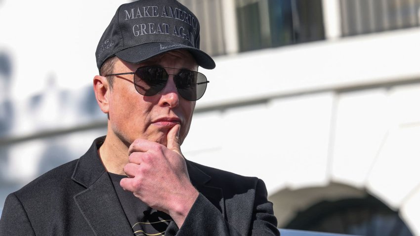 Tesla CEO Elon Musk watches as President Donald Trump talks to the media, outside the White House in Washington, D.C., March 11, 2025.