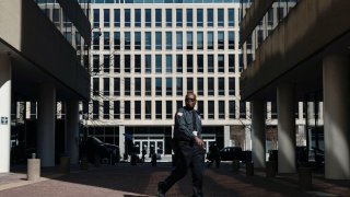 A security guard walks past the U.S. Department of Education headquarters in Washington, D.C., March 12, 2025.