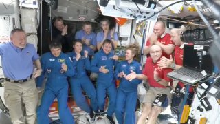 This image made from video by NASA shows astronauts greeting each other after a SpaceX capsule docked with the International Space Station, Sunday, March 16, 2025. Top row from left: Nick Hague, Alexander Gorbunov, Suni Williams, Alexei Ovchinin and Ivan Vagner. Bottom row from left: Butch Wilmore, Takuya Onishi, Anne McClain, Kirill Peskov, Nichole Ayers and Don Pettit.
