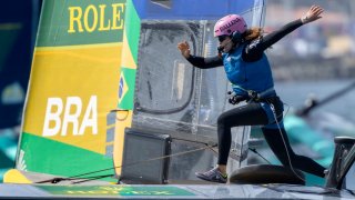 Martine Grael, driver of Mubadala Brazil SailGP Team, runs across the boat on Race Day 2 of the Rolex Los Angeles Sail Grand Prix held in the Port of Los Angeles, on Sunday, March 16, 2025.
