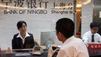 Shanghai, CHINA: A Chinese customer at a branch of the Bank of Ningbo on the eve of it’s IPO in Shanghai 18 July 2007. 