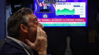 A screen broadcasting a news conference by U.S. Federal Reserve Chair Jerome Powell after a rate announcement, on the floor of the New York Stock Exchange on March 19, 2025.