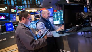 Traders work at the New York Stock Exchange on March 24, 2025.