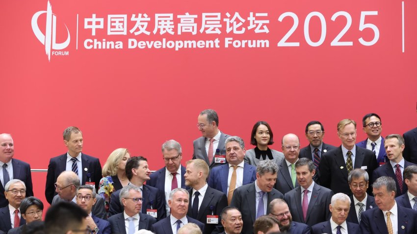 Attendees pose for a group photo before the opening ceremony of the China Development Forum 2025 at the Diaoyutai Guesthouse on March 23, 2025, in Beijing.