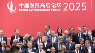 Attendees pose for a group photo before the opening ceremony of the China Development Forum 2025 at the Diaoyutai Guesthouse on March 23, 2025, in Beijing.