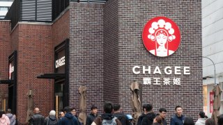 Pedestrians walk past a Chagee store in Shanghai, China, on March 14, 2025.
