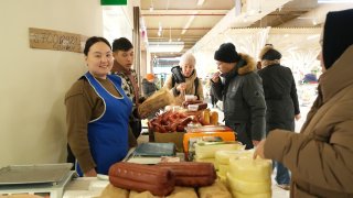 ASTANA, KAZAKHSTAN – JANUARY 26: People purchase sausages and cheese at the agricultural trade market on January 26, 2025 in Astana, Kazakhstan.