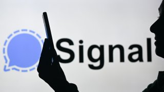 EDMONTON, CANADA – APRIL 28:
An image of a woman holding a cell phone in front of the Signal logo displayed on a computer screen, on April 29, 2024, in Edmonton, Canada. (Photo by Artur Widak/NurPhoto via Getty Images)