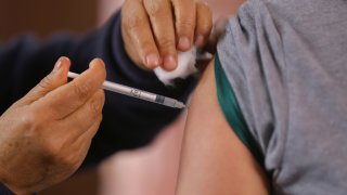 A person receives a dose of the human papillomavirus (HPV) vaccine