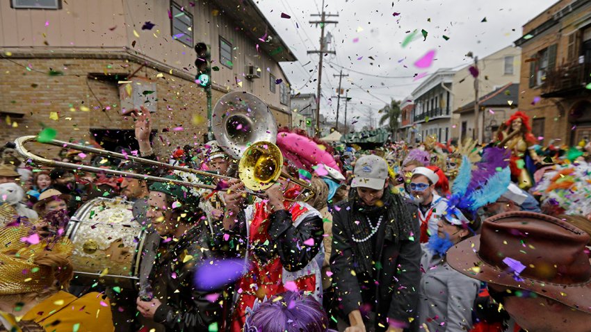 FILE - Revelers and musicians begin the march of the Society of Saint Anne Mardi Gras parade in New Orleans, Feb. 17, 2015.