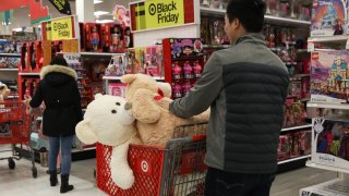 A customer pushes a shopping cart containing stuffed toys at a Target Corp. store in the Queens borough of New York, U.S, on Thursday, Nov. 28, 2019.