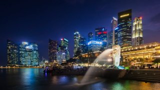 Singapore, city skyline and The Merlion, dusk