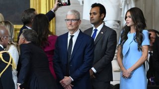 (L-R) Apple CEO Tim Cook, Vivek Ramaswamy and Secretary of Homeland Security nominee Kristi Noem attend the inauguration ceremony before Donald Trump is sworn in as the 47th US President in the US Capitol Rotunda in Washington, DC, on January 20, 2025.