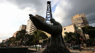 A sculpture of a hand holding an oil drilling rig is pictured outside the state-run oil company Petroleos de Venezuela S.A. in Caracas, Venezuela, on Feb. 26, 2025.