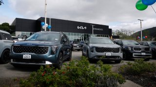 Brand new KIA cars are displayed on the sales lot at Serramonte Kia on March 26, 2025 in Colma, California.