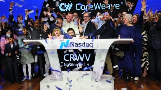 Mike Intrator, Chief Executive Officer and founder of CoreWeave, (C) rings the opening bell surrounded by Executive Leadership and family during the company’s Initial Public Offering (IPO) at the Nasdaq headquarters on March 28, 2025 in New York City.