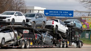 Trucks make their way to the Ambassador Bridge to cross into the United States at Detroit on April 1, 2025 in Windsor, Canada.