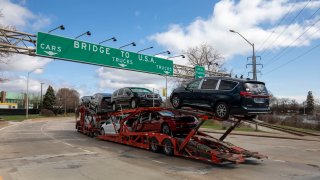 A car hauler truck makes its way to the Ambassador Bridge to cross into the United States at Detroit on April 1, 2025 in Windsor, Canada.