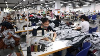 File: workers at the Maxport factory, which makes activewear for various textile clothing brands, in Hanoi.