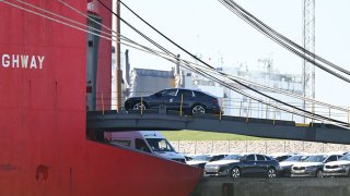 Cars from the Volkswagen Group are driven onto a car transporter for export.
