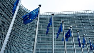 European flags fly in front of the Berlaymont building.