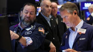 Traders work on the floor at the New York Stock Exchange (NYSE) in New York City, U.S., April 4, 2025. 