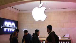 People shop at an Apple store in Grand Central Station in New York on April 4, 2025.