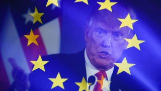 In this photo illustration, a double exposure images shows U.S. President Donald Trump against the EU flag.