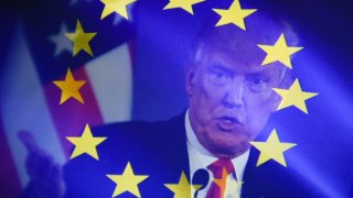 In this photo illustration, a double exposure images shows U.S. President Donald Trump against the EU flag.