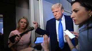 US President Donald Trump speaks to reporters while in flight on Air Force One, en route to Joint Base Andrews on April 6, 2025.