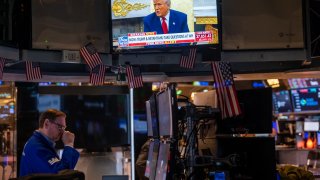 U.S. President Donald Trump is displayed on a television screen as traders work on the floor of the New York Stock Exchange (NYSE) on April 7, 2025 in New York City.