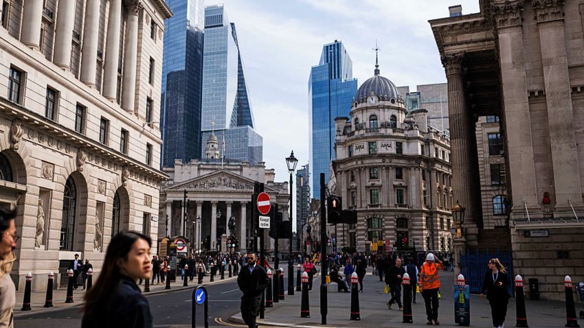 Workers cross a junction near the Bank of England (BOE) in the City of London, UK, on Tuesday, April 8, 2025. 