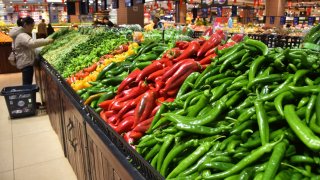 A customer selects vegetables at a supermarket in Mengzi City, southwest China’s Yunnan Province, Feb. 9, 2025.