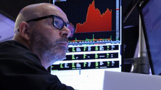 A trader works on the floor at the New York Stock Exchange (NYSE) in New York City, U.S., April 11, 2025. 