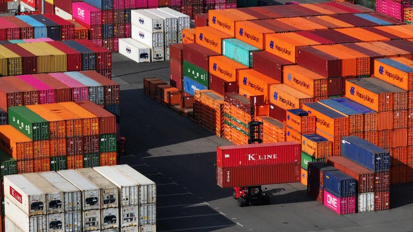 A forklift transports shipping containers among stacks of containers in Hamburg Port in Hamburg, Germany, April 15, 2025.