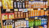 A row of sunscreens on a store shelf.