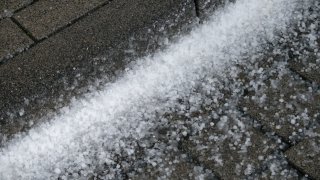 11 February 2020, North Rhine-Westphalia, Cologne: Graupel grains lie on a road during a thunderstorm. Photo: Henning Kaiser/dpa (Photo by Henning Kaiser/picture alliance via Getty Images)