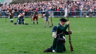 Reenactors depicting deceased members of the Lexington Minute Men arise after the 250th reenactment of the Battle of Lexington and Concord