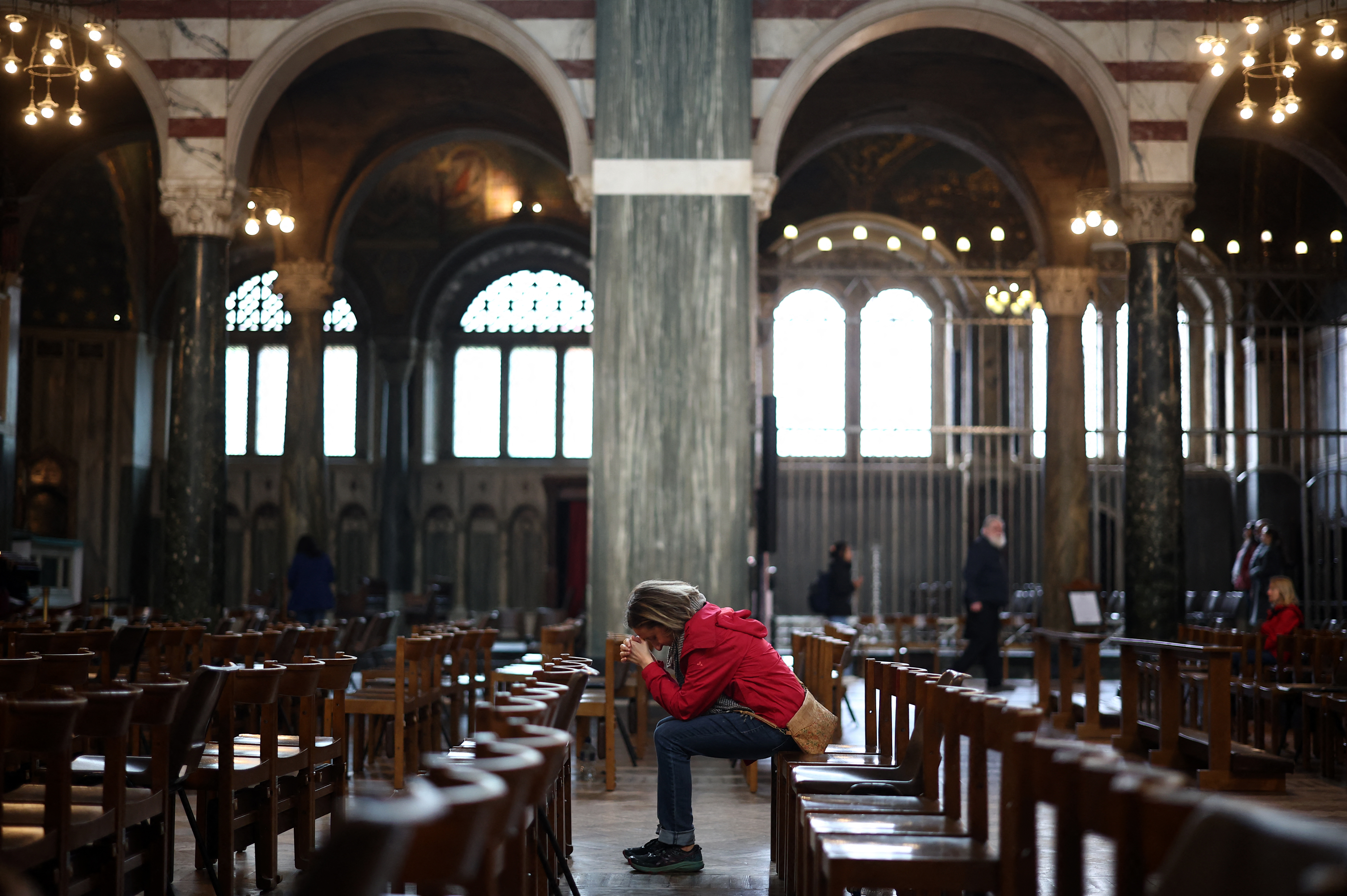 A worshipper sits in a pew inside Westminster Cathedral, in central London on April 21, 2025.