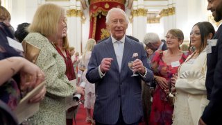 King Charles III speaks to guests at Buckingham Palace on April 30, 2025 in London, England.