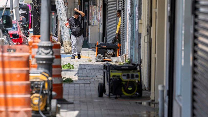 Generators line the sidewalk of a commercial street in Barrio Obrero as shops try to remain open during a prolonged power outage in San Juan, Puerto Rico, Thursday, April 17, 2025.