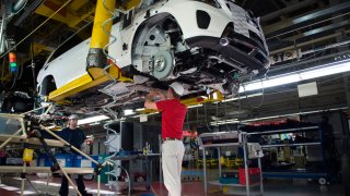 An employee installs parts on the undercarriage of a Mercedes-Benz GLS-Class SUV at the Mercedes-Benz U.S. International factory in Vance, Alabama, on June 8, 2017.