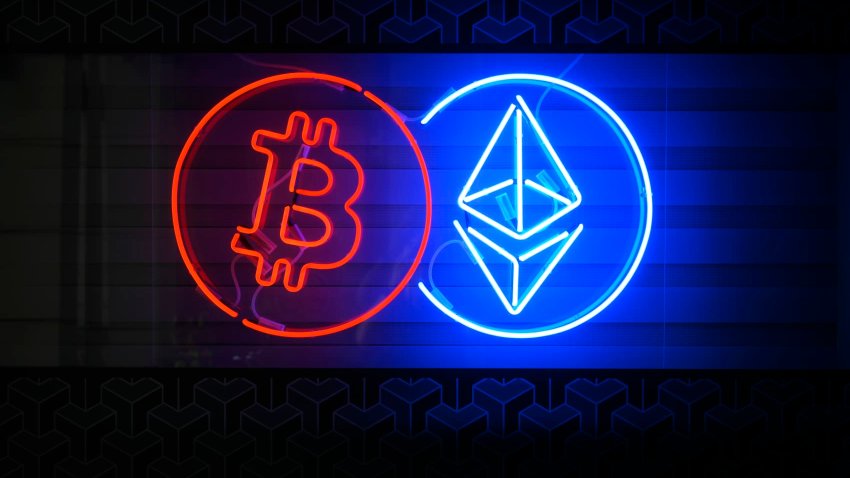 People walk past a neon sign advertising a Bitcoin and Ethereum crypto currency exchange in Warsaw, Poland on 19 May, 2024. 