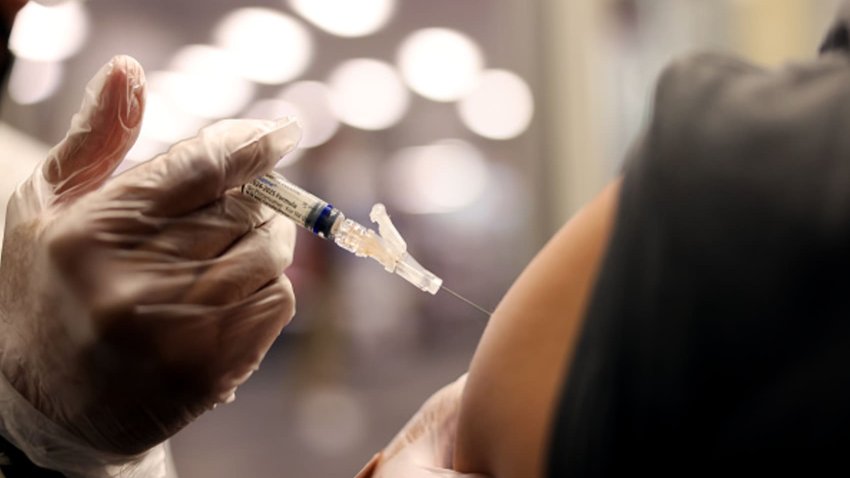 Brandon Guerrero, 34, of Compton, receives both a flu and COVID-19 vaccine at CVS in Huntington Park on August 28, 2024.