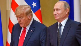 Donald Trump (L) and Russia’s Vladimir Putin arrive to attend a joint press conference after a meeting at the Presidential Palace in Helsinki, on July 16, 2018.