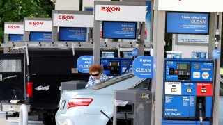 FILE PHOTO: A motorist fills up at an Exxon service station in Burke, Virginia.